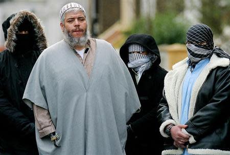 A file photograph dated February 7, 2003 shows Muslim cleric Sheikh Abu Hamza (2L) outside the North London Mosque at Finsbury Park surrounded by supporters.