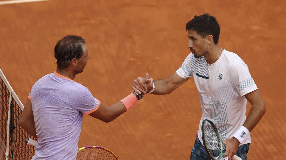 Nadal and Cachín shake hands at the net after their Madrid Open match. - Clive Brunskill/Getty Images