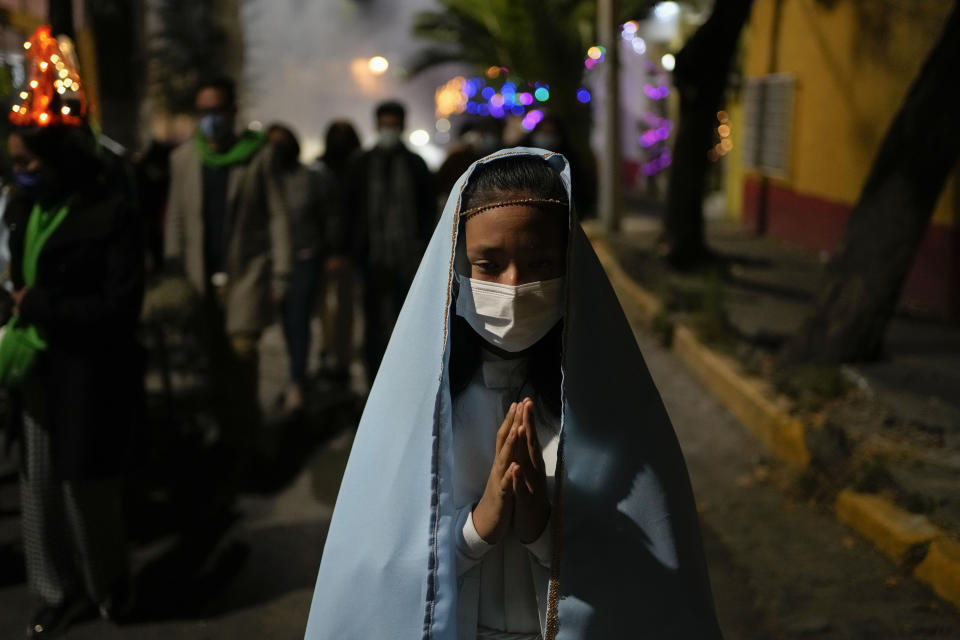 Residents participate in the procession of "Niñopan" during a Christmas "posada," which means lodging or shelter, in the Xochimilco borough of Mexico City, Wednesday Dec. 21, 2022. For the past 400 years, residents have held posadas between Dec. 16 and 24, when they take statues of baby Jesus in procession to church for Mass to commemorate Mary and Joseph's cold and difficult journey from Nazareth to Bethlehem in search of shelter. (AP Photo/Eduardo Verdugo)