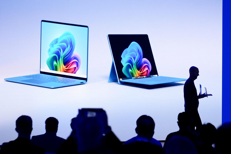 Brett Ostrum, Microsoft corporate vice president of Surface, walks out with the new Surface Laptop and Surface Pro with built-in AI hardware during a showcase event of the company's AI assistant, Copilot, at Microsoft headquarter,s Monday, May 20, 2024, in Redmond, Wash. (AP Photo/Lindsey Wasson)