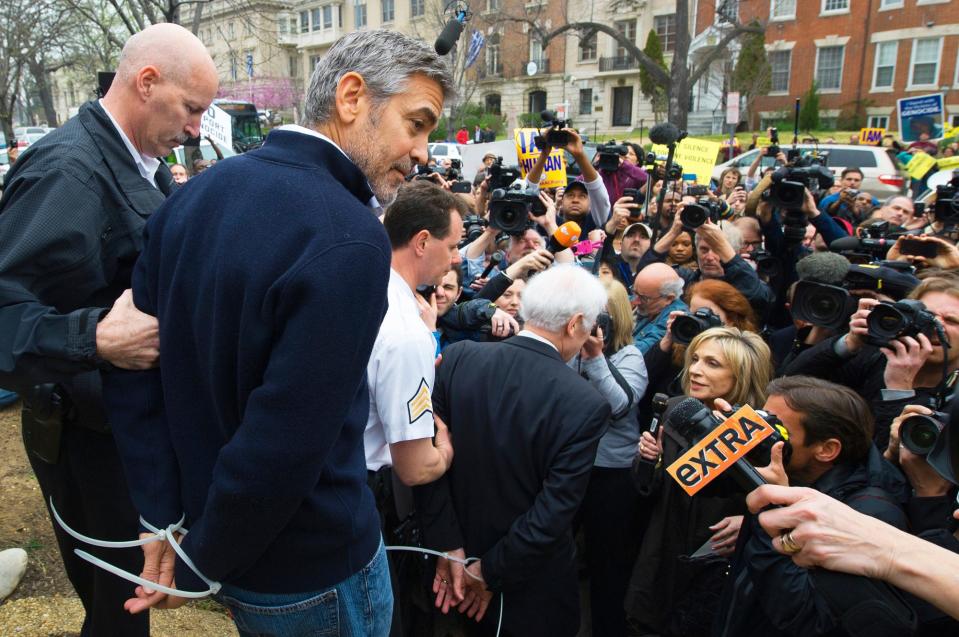 <p>Clooney and his father Nick <a href="https://people.com/crime/george-clooney-arrested-protesting-at-sudanese-embassy/" rel="nofollow noopener" target="_blank" data-ylk="slk:were arrested;elm:context_link;itc:0;sec:content-canvas" class="link ">were arrested</a> (and later released) in March 2012 during a Washington, D.C., protest against human rights abuses by the Sudanese government. </p> <p>“This is for the government in Khartoum to stop randomly killing its own innocent men, women and children. Stop raping them and stop starving them. That’s all we ask,” he said as he walked away. </p> <p><a href="https://people.com/crime/george-clooney-arrested-protesting-at-sudanese-embassy/" rel="nofollow noopener" target="_blank" data-ylk="slk:Clooney had said;elm:context_link;itc:0;sec:content-canvas" class="link ">Clooney had said</a> earlier in interviews that if steps were not taken in the coming months to help the nation, “We’re going to have a real humanitarian disaster.” </p>