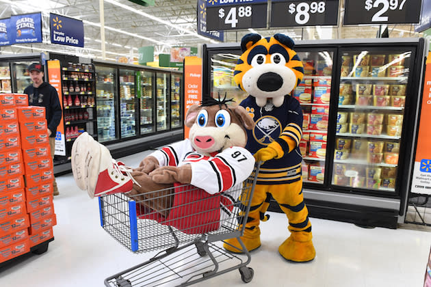 MARQUETTE, MI - OCTOBER 2 : Carolina Hurricanes and Buffalo Sabres mascots have fun while Brad May signs autographs for fans at Walmart on October 2, 2016 in Marquette, Michigan. (Photo by Brian Babineau/NHLI via Getty Images)