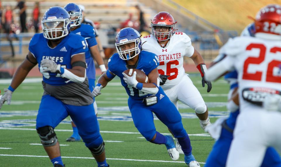 Lake View running back Ian Cortez (middle) navigates through traffic while running with the football against Sweetwater at San Angelo Stadium on Sept. 1, 2023.