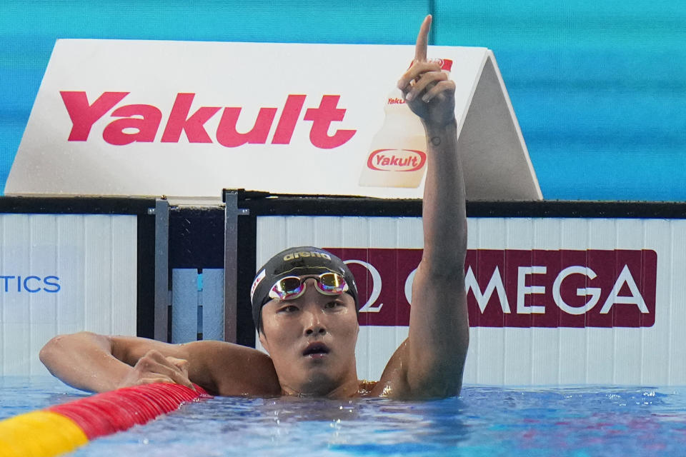 Kim Woo-min of South Korea celebrates after winning the men's 400-meter freestyle final at the World Aquatics Championships in Doha, Qatar, Sunday, Feb. 11, 2024. (AP Photo/Hassan Ammar)