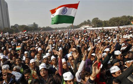 Supporters of Aam Aadmi (Common Man) Party (AAP) wave as they listen to a speech by their leader Arvind Kejriwal (unseen) after he took an oath as the new chief minister of Delhi during a swearing-in ceremony at Ramlila ground in New Delhi December 28, 2013. REUTERS/Anindito Mukherjee