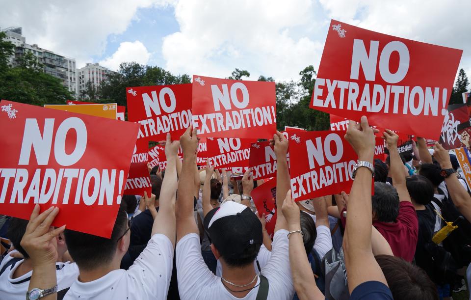 HONG KONG, CHINA - 2019/06/09: Demonstrators hold placards during the anti extradition march. Hundreds of thousands of demonstrators took to the street of Hong Kong to protest against the extradition bill being put forward by the Hong Kong government which the people of Hong Kong fear it could be used as a political tool by the Beijing central government to arrest and transfer political activists who are against the Chinese government to the mainland. (Photo by Alvin Chan/SOPA Images/LightRocket via Getty Images)