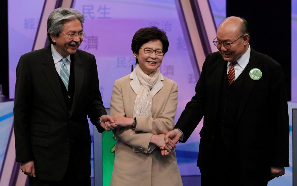 John Tsang, Carrie Lam and Woo Kwok-hing - AP