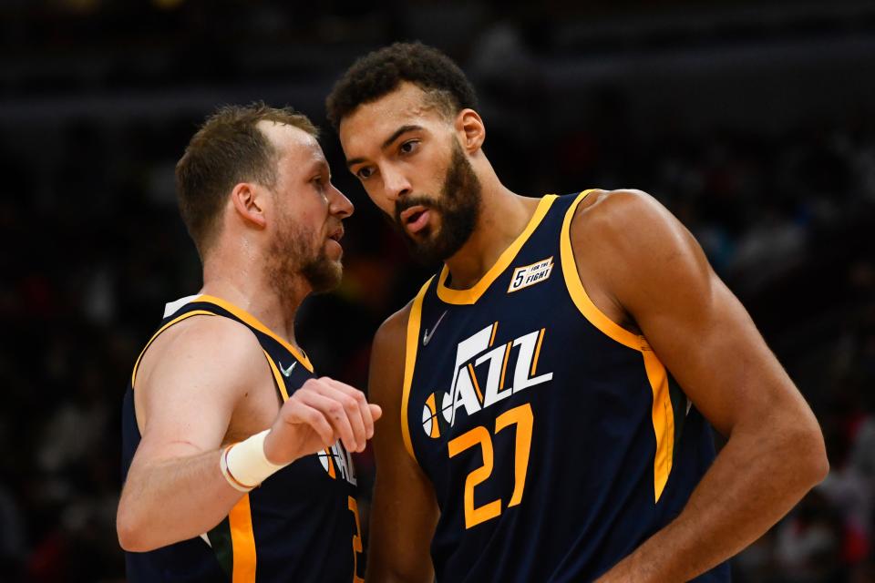 Utah Jazz guard Joe Ingles, left, and center Rudy Gobert (27) talk during the first half of an NBA basketball game against the Chicago Bulls, Saturday, Oct. 30, 2021, in Chicago. (AP Photo/Matt Marton).