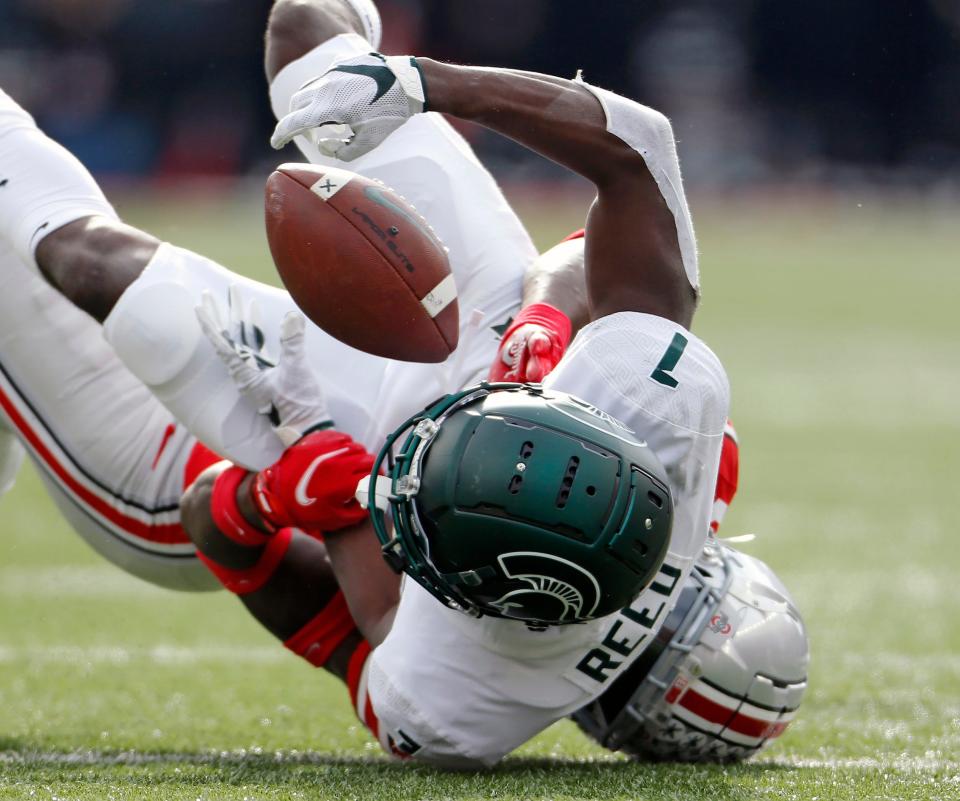 Ohio State Buckeyes cornerback Denzel Burke knocks the ball away from Michigan State Spartans wide receiver Jayden Reed, forcing an incompletion in the first quarter at Ohio Stadium in Columbus on Nov. 20, 2021.