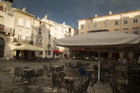 Cafes and restaurants are empty on the Roman forum in Pula, Croatia, Tuesday, May 26, 2020. "Our Dream Their Smile" group has helped people in the tourism-dependent area in the Adriatic survive as the outbreak closed down borders, shutting down hotels, restaurants and other businesses that normally thrive in virus-free times. (AP Photo/Darko Bandic)