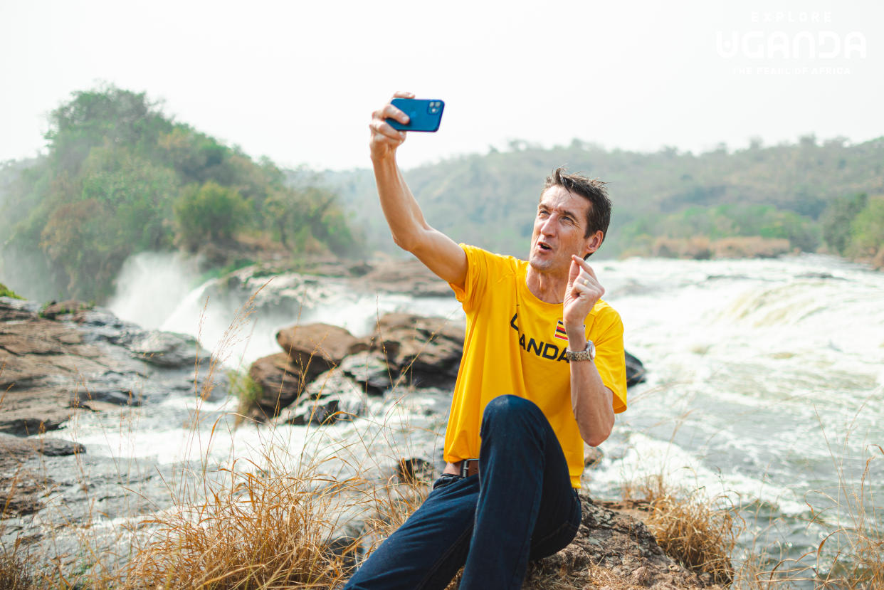 Sports commentator Rob Walker taking a selfie in front of Murchison Falls in Uganda