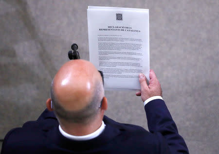 A declaration of independence is read out after it was signed by members of the Catalan regional government at the Catalan regional parliament in Barcelona, Spain, October 10, 2017. REUTERS/Juan Medina