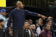Orlando Magic coach Jamahl Mosley directs players during the first half of the team's NBA basketball game against the Golden State Warriors, Wednesday, March 27, 2024, in Orlando, Fla. (AP Photo/John Raoux)