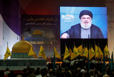 FILE PHOTO: Lebanon's Hezbollah leader Sayyed Hassan Nasrallah addresses his supporters via a screen during a rally marking Al-Quds day in Beirut's southern suburbs, Lebanon June 23, 2017. REUTERS/Aziz Taher/File Photo