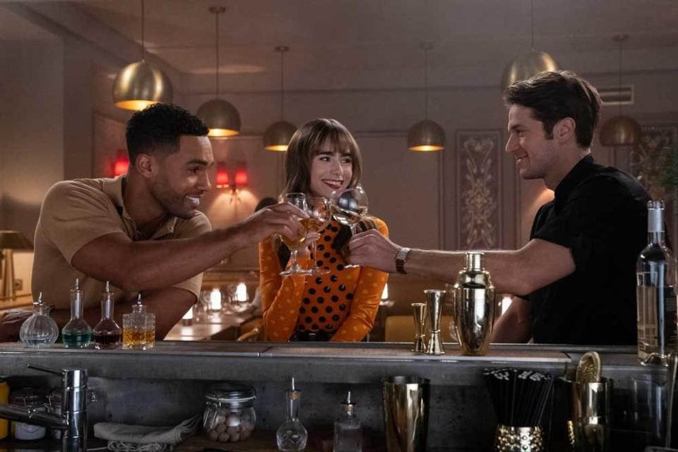 Alfie, Gabriel and Emily cheering with drinks