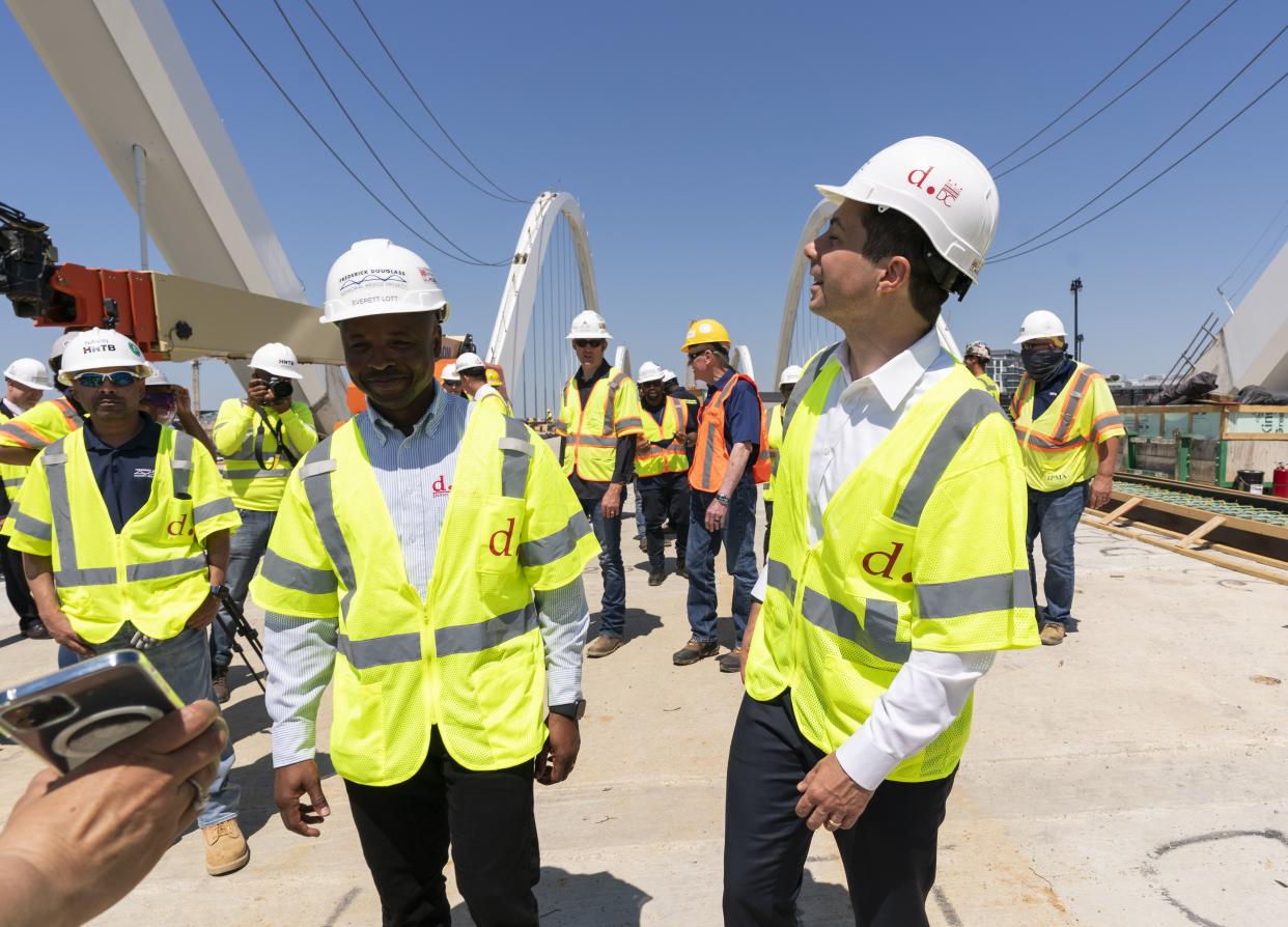 Secretary of Transportation Pete Buttigieg, right, visits the Frederick Douglass Memorial Bridge construction site with District of Columbia Mayor Muriel Bowser and Secretary of Labor Marty Walsh,  Wednesday, May 19. 