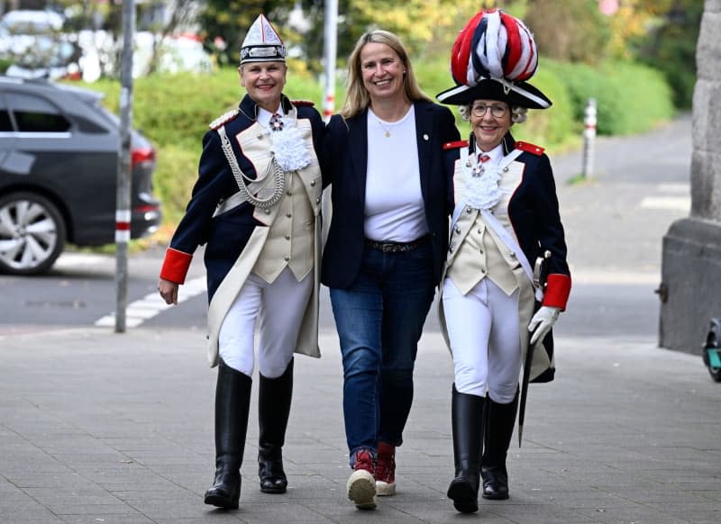 Carnivalists Monika Kissing (l) and Bettina Schwerer (r) presenting their French Revolution-style costumes together with Barbara Brüninghaus, president of the First Coeln Ladies' Guard, one of seven women's Carnival societies in the western German city of Cologne and the only one in which uniforms are worn. Roberto Pfeil/dpa