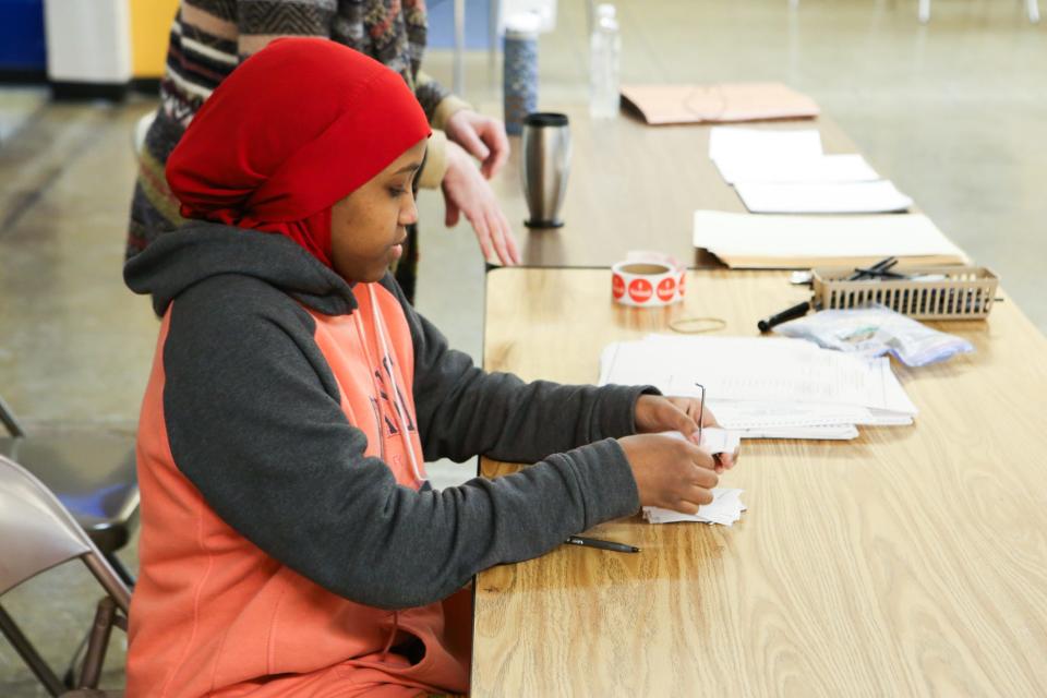 A Minneapolis student works at a polling place Jan. 21