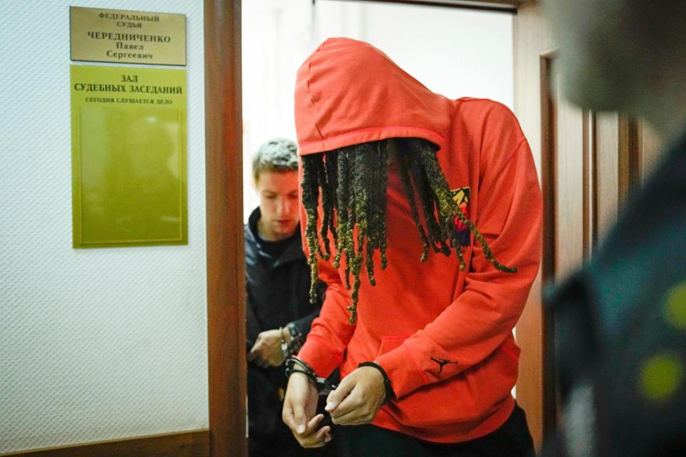 WNBA star and two-time Olympic gold medalist Brittney Griner leaves a courtroom after a hearing, in Khimki just outside Moscow, Russia, Friday, May 13, 2022. Griner, a two-time Olympic gold medalist, was detained at the Moscow airport in February after vape cartridges containing oil derived from cannabis were allegedly found in her luggage, which could carry a maximum penalty of 10 years in prison.  (AP Photo/Alexander Zemlianichenko)