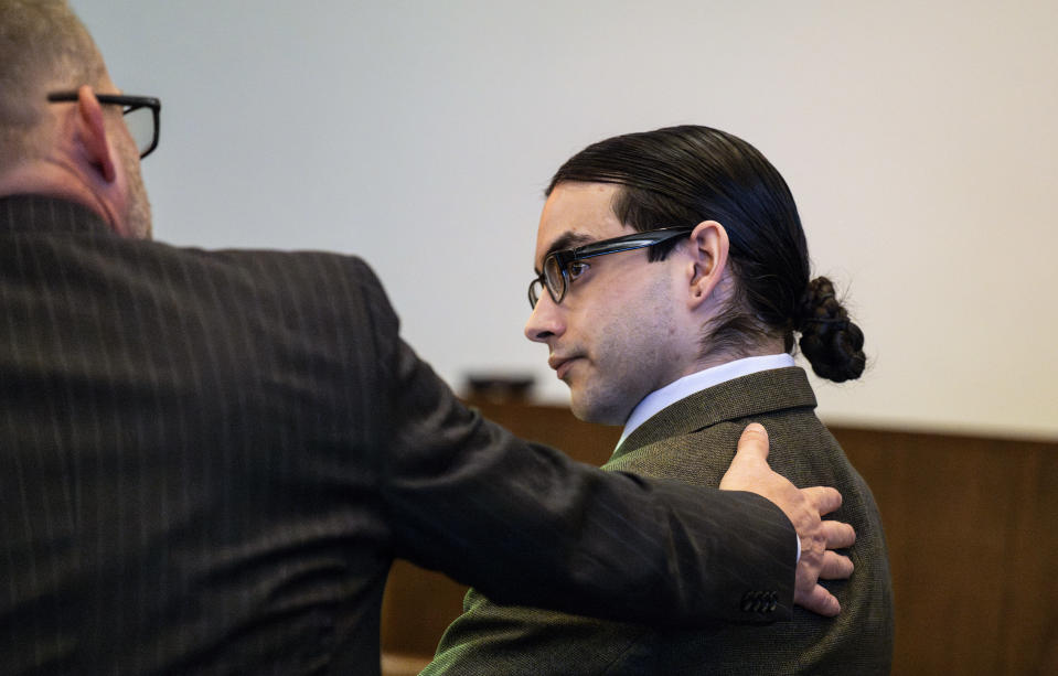 Defendant Marcus Eriz talks with his attorney Randall Bethune before opening statements in his trial, Thursday, Jan. 18, 2024, in Santa Ana, Calif. Eriz, 26, is charged with killing Aiden Leos, 6, while the boy's mother was driving him to kindergarten in Orange County in May 2021. (Paul Bersebach/The Orange County Register via AP)