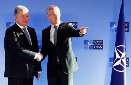 Ukrainian President Petro Poroshenko poses with NATO's Secretary General Jens Stoltenberg ahead of a meeting at the Alliance's headquarters in Brussels, Belgium December 13, 2018. REUTERS/Francois Lenoir