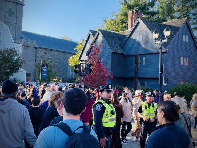 Salem PD helping pedestrians cross Essex St. by the Witch House in slem