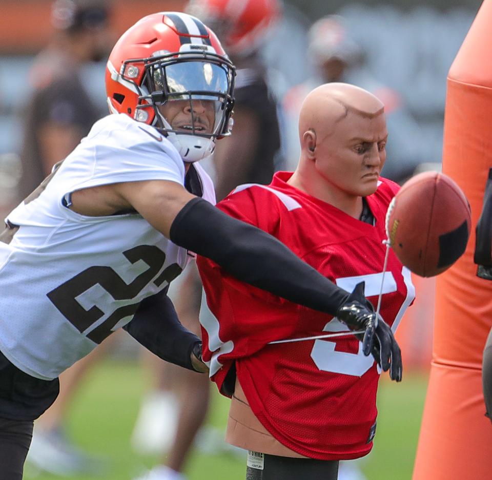 Cleveland Browns safety Grant Delpit knocks the ball from a tackling dummy during training camp on Friday, July 29, 2022 in Berea.