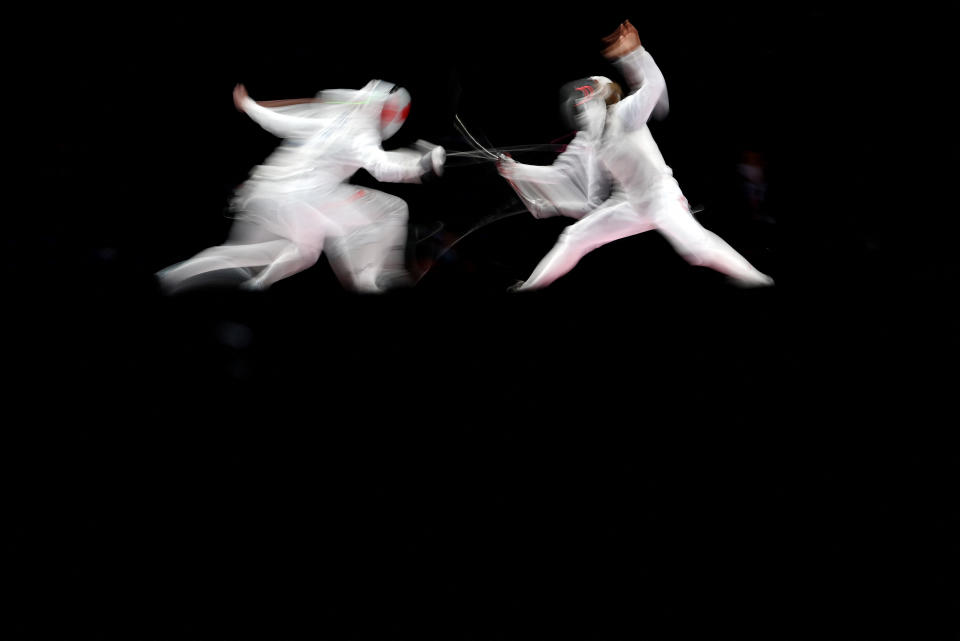 <p>Japan's Sera Azuma (R) compete against Canada's Kelleigh Ryan in the women's foil individual qualifying bout during the Tokyo 2020 Olympic Games at the Makuhari Messe Hall in Chiba City, Chiba Prefecture, Japan, on July 25, 2021. (Photo by Fabrice COFFRINI / AFP)</p> 