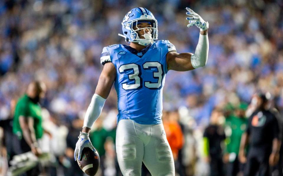 North Carolina’s Cedric Gray (33) reacts after intercepting Miami quarterback Tyler Van Dyke in the third quarter on Saturday, October 14, 2023 at Kenan Stadium in Chapel Hill, N.C.