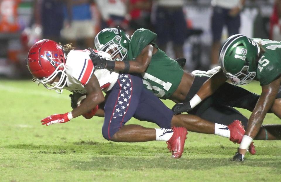 Manatee wide receiver Bon Bean Jr. (10) is brought down by Venice cornerback Kyni Brantley (31) Friday night in Venice, Florida. The Indians defeated the Hurricanes 56-24. MATT HOUSTON/HERALD-TRIBUNE