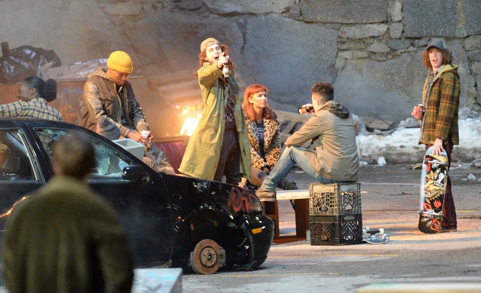 Anania Williams (left, wearing his signature yellow beanie) appeared in a scene with Timothee Chalamet and Jennifer Lawrence in Netflix's Oscar-nominated disaster film "Don't Look Up."