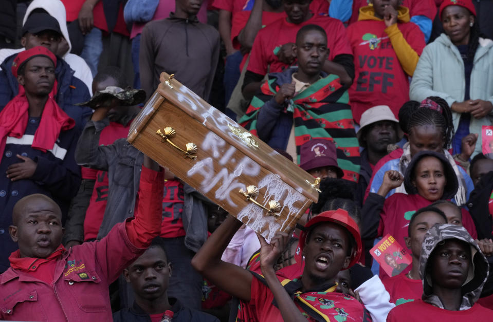 Supporters of the Economic Freedom Fighters (EFF), with a mock coffin representing the ruling African National Congress, attend a final election rally in Polokwane, South Africa, Saturday, May 25, 2024. South African will vote in the 2024 general elections May 29. (AP Photo/Themba Hadebe)