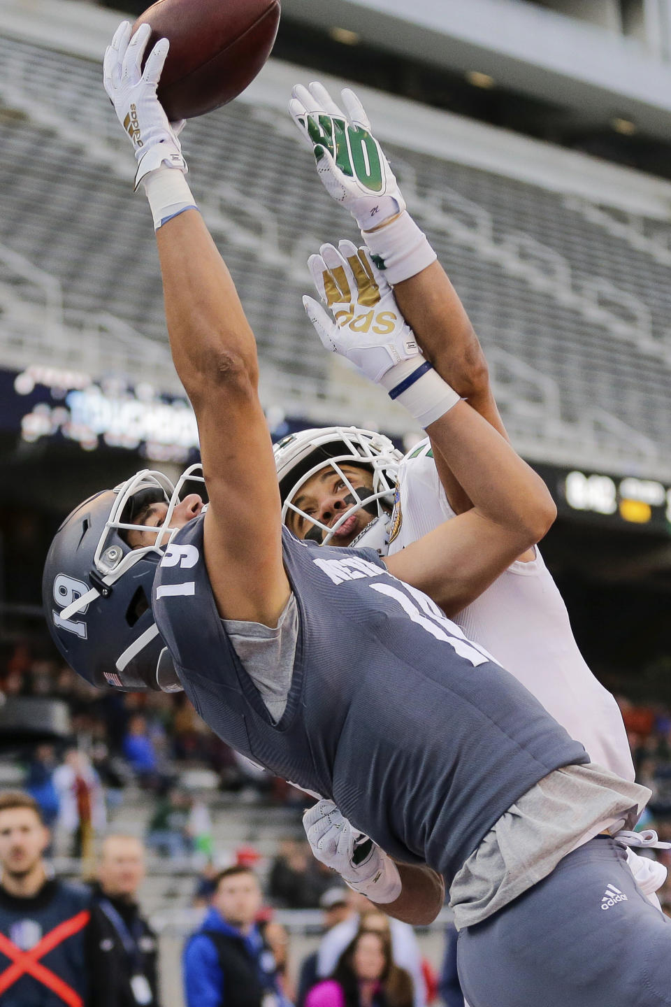 Ohio cornerback Marlin Brooks, right, tries to knock the ball away from Nevada wide receiver Cole Turner (19) on a two-point conversion try late in the second half of the Famous Idaho Potato Bowl NCAA college football game, Friday, Jan. 3, 2020, in Boise, Idaho. (AP Photo/Steve Conner)