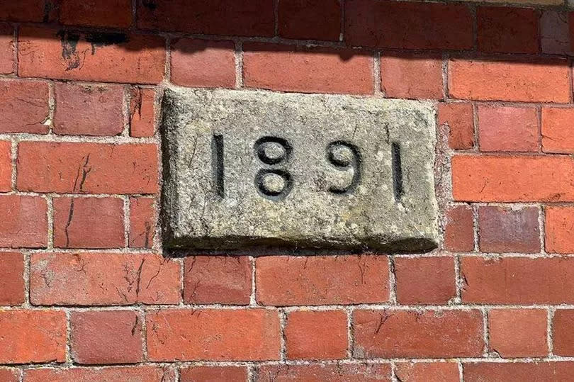 A stone plaque gives the building's date of construction