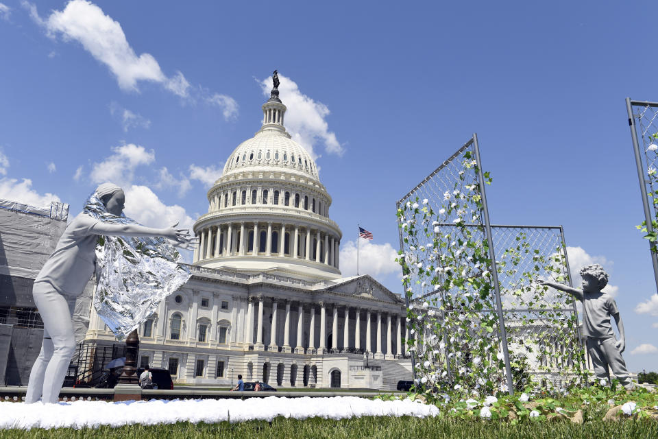 FILE - An art installation, on display outside the Capitol in Washington shows a mother reaching out to her child to mark the first anniversary of the Trump administration's "zero tolerance" family separation policy, on Tuesday, May 7, 2019. Stalled negotiations for the U.S. government to pay families separated at the border during Donald Trump's presidency have brought new threats of extortion. While specific reports are isolated, widespread extortion in Central America explains why many seek asylum in the United States in the first place and some advocates fear prospects of a large payment will fuel many more threats. It is far from clear whether families will receive any money at all from the U.S. government. (AP Photo/Susan Walsh, File)