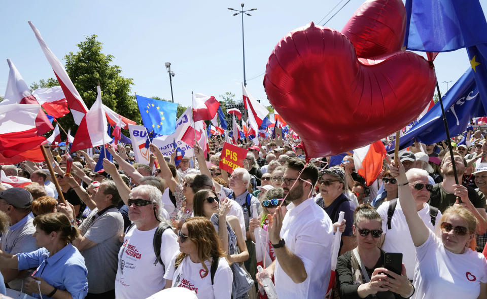 Participants join an anti-government march led by the centrist opposition party leader Donald Tusk, who along with other critics accuses the government of eroding democracy, in Warsaw, Poland, Sunday, June 4, 2023. Poland's largest opposition party led a march Sunday meant to mobilize voters against the right-wing government, which it accuses of eroding democracy and following Hungary and Turkey down the path to autocracy. The march is being held on the 34th anniversary of the first partly free elections, a democratic breakthrough in the toppling of communism across Eastern Europe. (AP Photo/Czarek Sokolowski)