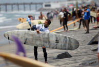 OCEANSIDE, CA - MAY 6: Surfers prepare go into the surf for a ceremony during a "paddle-out" in honor of NFL star Junior Seau on May 6, 2012 in Oceanside, California. Seau, who played for various NFL teams including the San Diego Chargers, Miami Dolphins and New England Patriots was found dead in his home on May 2nd of an apparent suicide. Family members have decided to donate his brain for research on links between concussions and possible depression. (Photo by Sandy Huffaker/Getty Images)