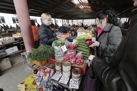 People shop in a market in Daugavpils March 22, 2014. REUTERS/Ints Kalnins