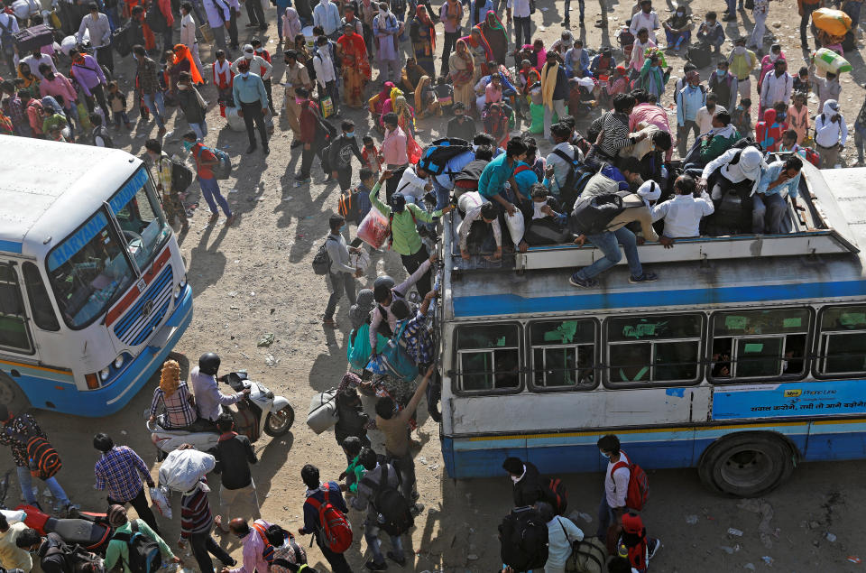 Migrant workers travel on crowded buses as they return to their villages, during a 21-day nationwide lockdown to limit the spreading of coronavirus disease (COVID-19), in Ghaziabad, on the outskirts of New Delhi, India, March 29, 2020. REUTERS/Adnan Abidi