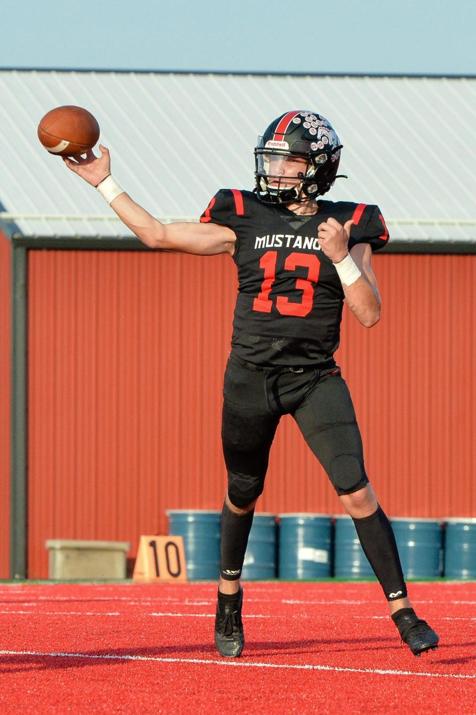 Jakob Lanning (13) makes a pass for the Mustangs during a scrimmage against Bloomington North Friday night at Edgewood. 