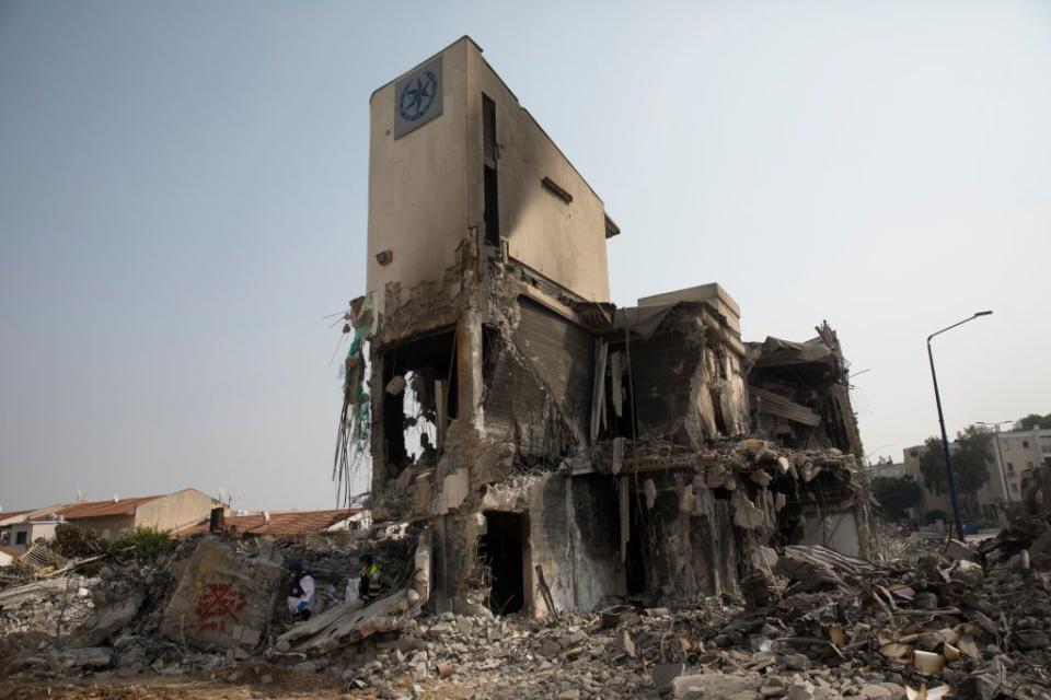 Israeli rescue members work at a police station that was destroyed after a battle between Israeli troops and Hamas militants on October 8, 2023 in Sderot, Israel. On Saturday, the Palestinian militant group Hamas launched the largest surprise attack from Gaza in a generation, sending thousands of missiles and an unknown number of fighters by land, who shot and kidnapped Israelis in communities near the Gaza border. The attack prompted retaliatory strikes on Gaza and a declaration of war by the Israeli prime minister.