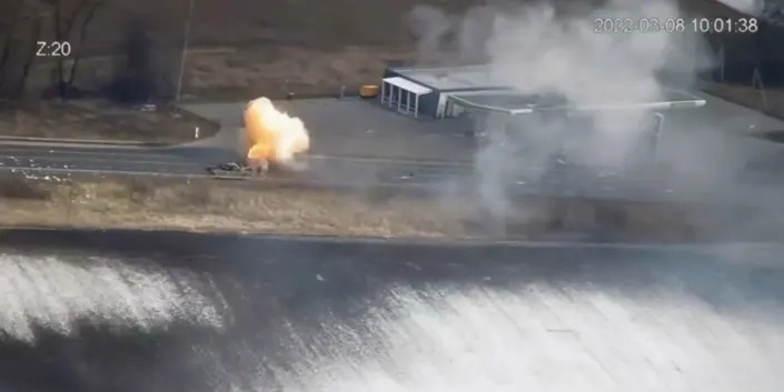 A screenshot from a video released by the Ukrainian defense ministry, showing a road outside Borodyanka with a burst of smoke where Russian vehicles were reportedly targeted