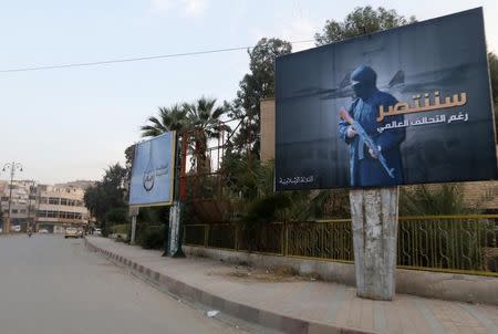 Islamic State billboards are seen along a street in Raqqa, eastern Syria, which is controlled by the Islamic State, October 29, 2014. REUTERS/Nour Fourat