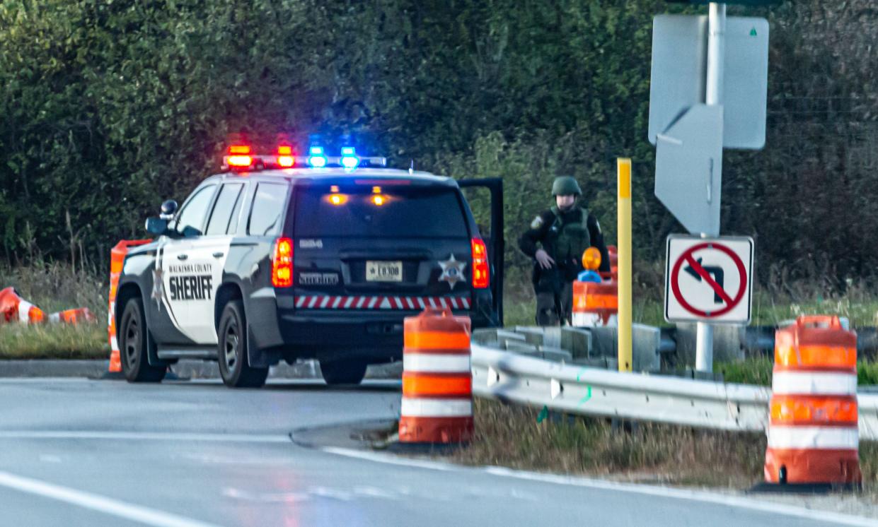 A heavily armed officer from the Waukesha County Sheriff's Department blocks the ramp to I-94 at Highway 83 in Delafield after two officers were shot early Friday, November 6, 2020. Police have arrested a North Dakota man in connection with the nonfatal shootings of two police officers in Delafield.