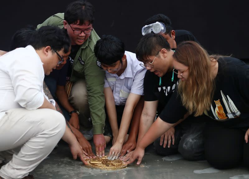 Student leaders install a plaque near the Grand Palace in Bangkok