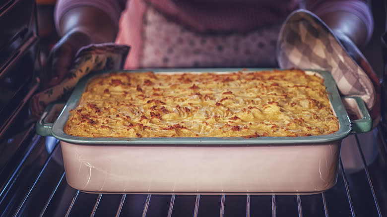 Pulling casserole from oven