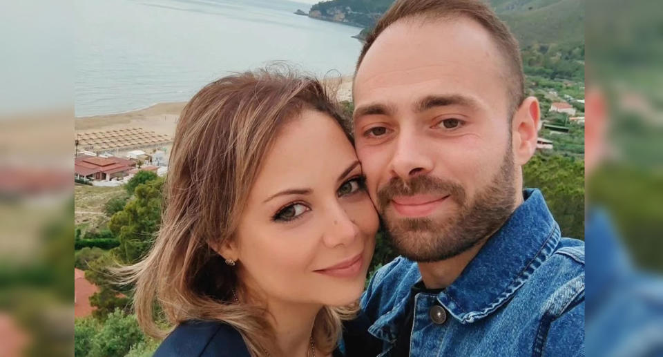 Laura Porta with her partner Antonio standing in front of beach. 