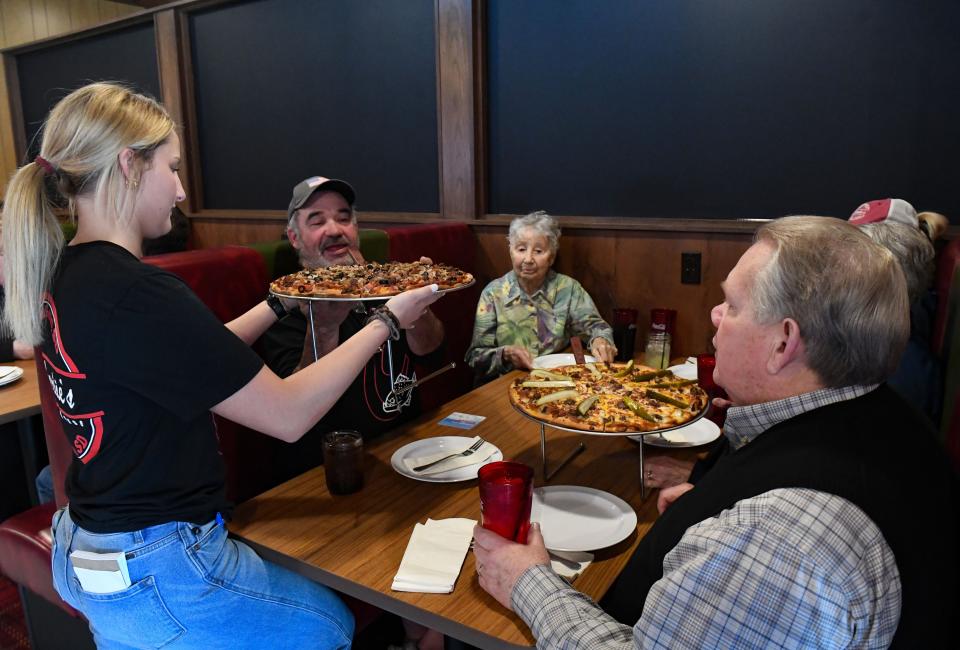 Guests are served the first pizzas during a soft opening on Thursday, March 25, 2022, at the new Charlie's Pizza location in Sioux Falls.