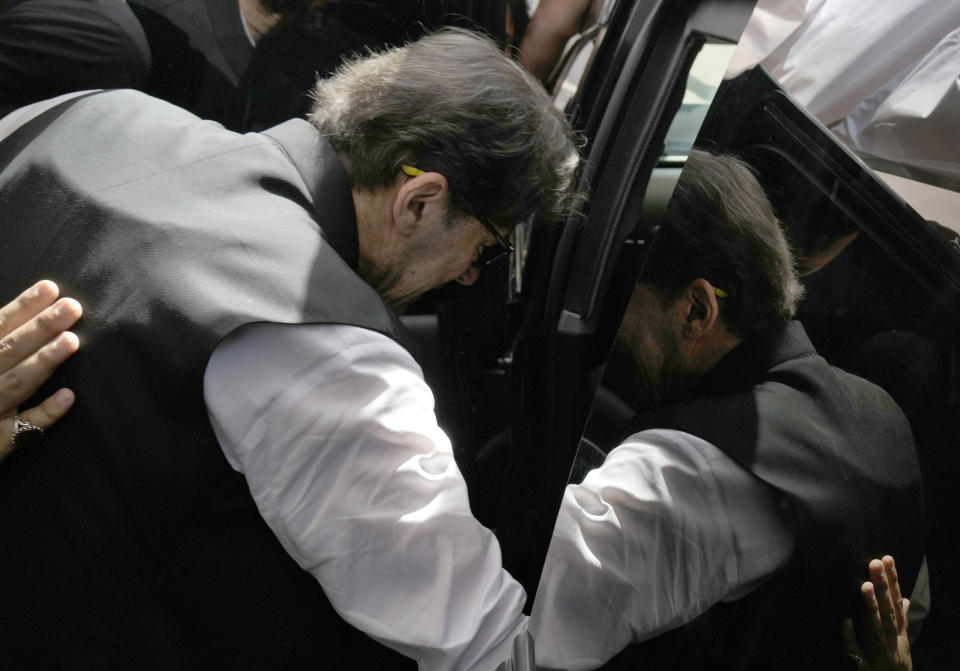 Pakistan's former Prime Minister Imran Khan gets into his vehicle after his court appearance, in Lahore, Pakistan, Monday, May 15, 2023. Thousands of Pakistani government supporters converged on the country's Supreme Court on Monday, in a rare challenge to the nation's judiciary. Protesters demanded the resignation of the chief justice over ordering the release of former Prime Minister Imran Khan.(AP Photo/K.M. Chaudary)