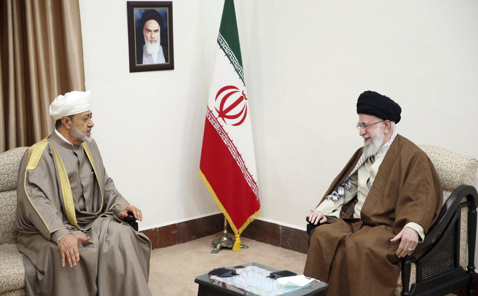 In this picture released by the office of the Iranian supreme leader, Supreme Leader Ayatollah Ali Khamenei, right, meets with Oman's Sultan Haitham bin Tariq Al Said, in Tehran, Iran, Monday, May 29, 2023. A portrait of the late Iranian revolutionary founder Ayatollah Khomeini hangs on the wall. (Office of the Iranian Supreme Leader via AP)